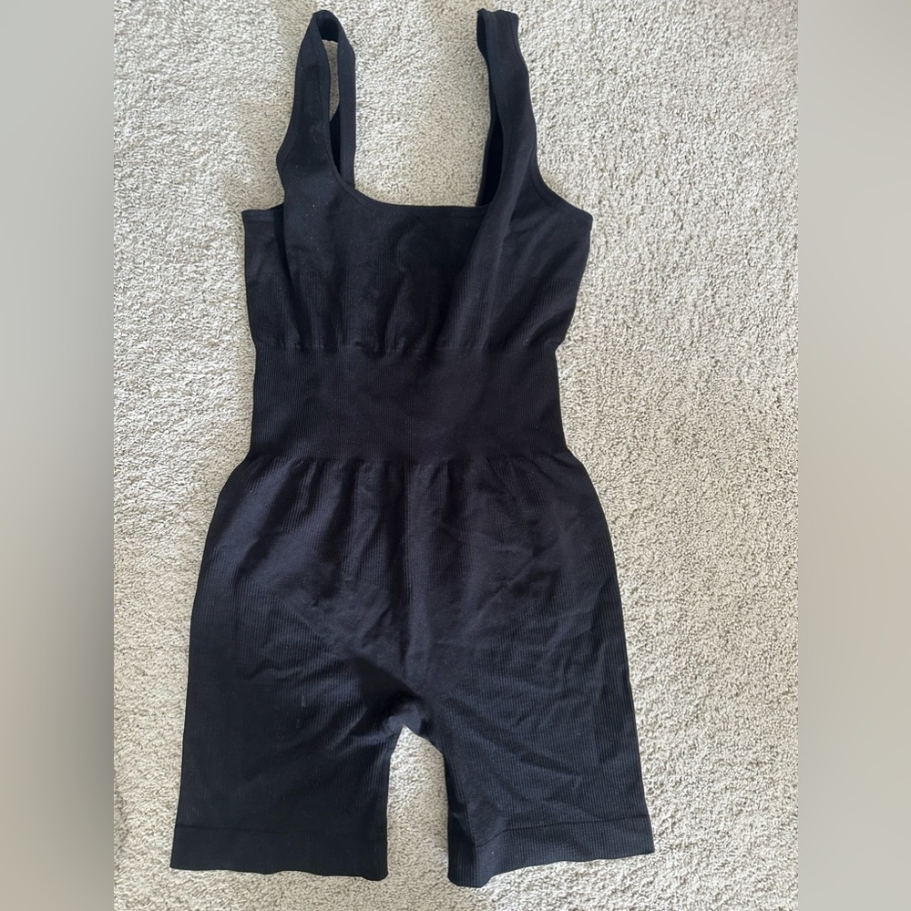WEWOREWHAT BLACK ONSIE. NEVER WORN.